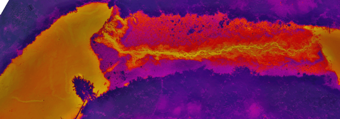 Thermal aerial survey showing heat signatures with purple cooler areas and orange-yellow warmer zones indicating temperature variations across terrain